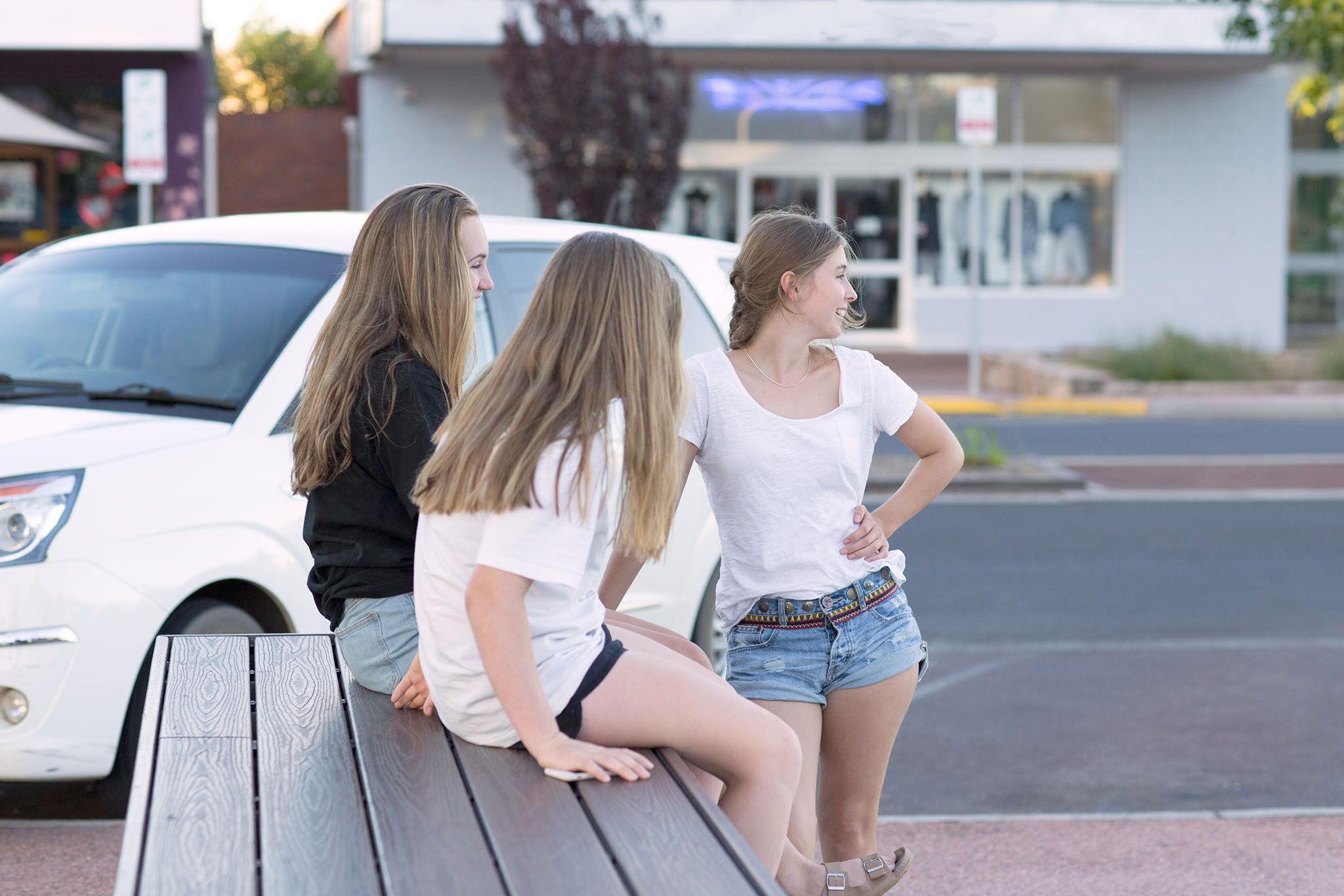 Stock photo of three teenage girls in the street, by caro telfer, photographer