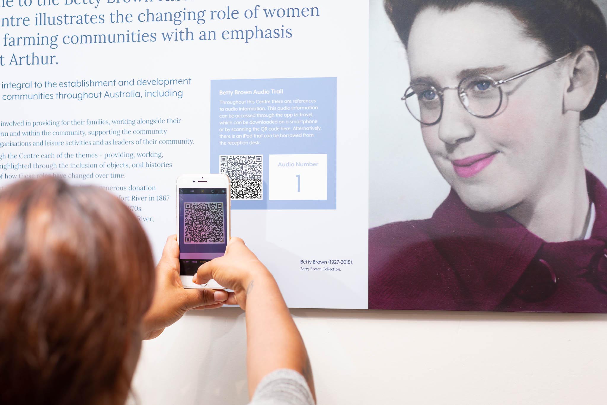 Museum visitor scanning QR code with smartphone. Photo by Caro Telfer.